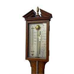 20th century - mercury cistern barometer in an 18th century style mahogany case with contrasting inlay and a broken pediment, round base with a turned cistern cover, fully exposed glass tube and silvered register within a glazed door, with a Fahrenheit spirit thermometer, engraved weather predictions and sliding vernier. Mercury clean and present.
