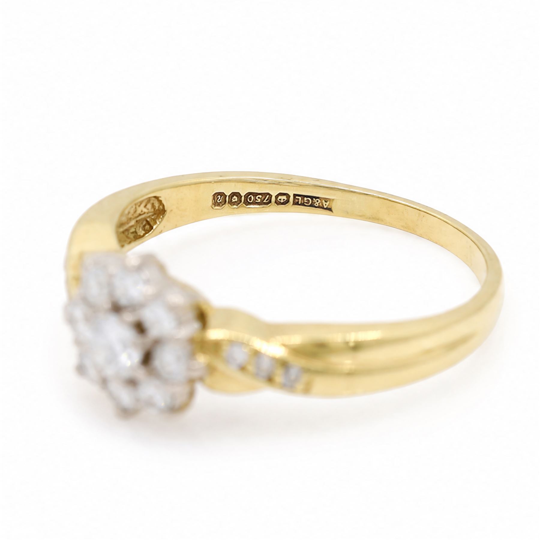 18ct gold diamond flower head cluster ring, set with nine round brilliant cut diamonds, with diamond set shoulders, London 1991, total diamond weight approx 0.40 carat