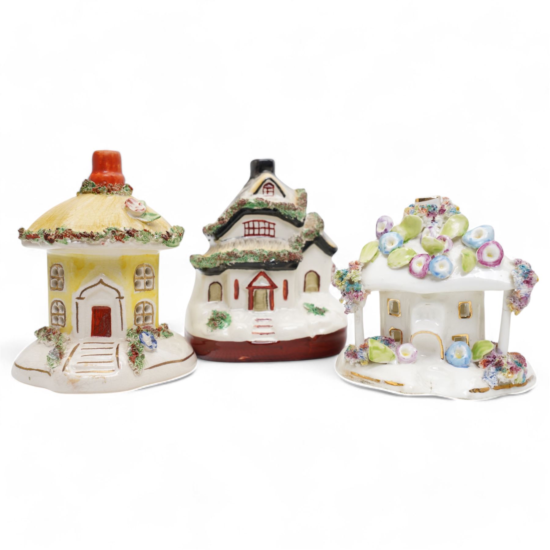 19th century pottery money box in the form of a two storey house with applied floral decoration W14cm  and six pottery cottage pastille burners