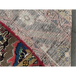 Persian Hamadan rug, the rosette pole medallion on a pale field decorated with stylised motifs, the blue band border decorated with stylised flower heads