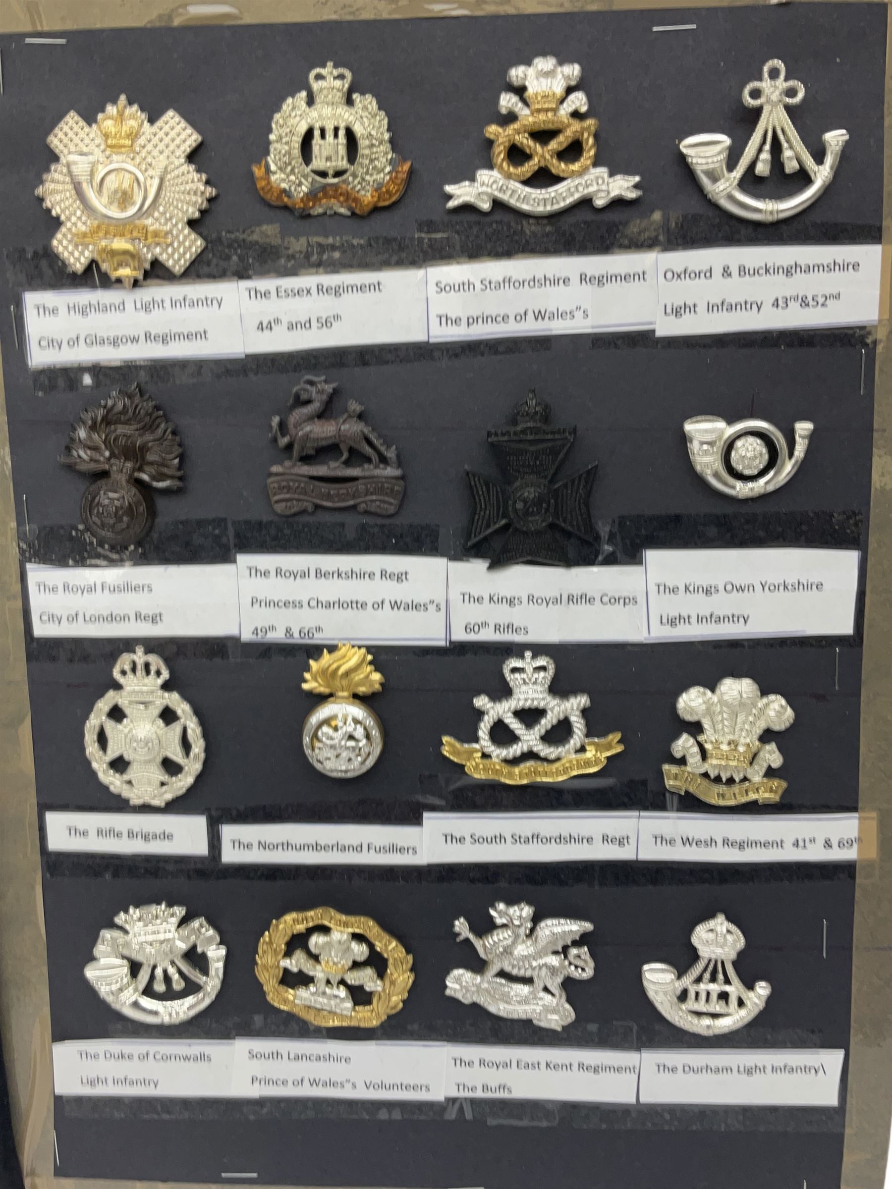 Collection of thirty-two reproduction military badges, including Royal Scots Fusiliers, Royal Lincolnshire Regiment, The Boarders Regiment etc. 