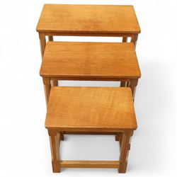Mouseman - nest of three oak occasional tables, rectangular adzed top, on octagonal supports united by plain stretchers, each carved with mouse signature, by the workshop of Robert Thompson, Kilburn