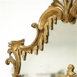 George III Chippendale design carved giltwood and gesso wall mirror, the impressive protruding pierced pediment decorated with flared acanthus leaves interspersed with flower heads and berries, over an arched outer-frame - the cresting comprised of C-scrolls carved with dripping icicle motifs, the uprights formed of scrolling acanthus with swags of grapevines and foliage, over a scrolled cartouche terminal, the inner-frame of architectural form with bell-flower details and a shaped cresting with scrolling acanthus leaves, all enclosing a central slightly bevelled rectangular mercury glass plate, surrounded by smaller plates