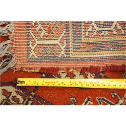 Two hand-knotted rugs, comprising Turkoman Ersari rug and Bokhara rug, Turkoman Ersari hand-knotted rug, terracotta ground with two rows of repeating octagonal guls interspersed with geometric motifs, enclosed by multiple geometric borders, fringed ends, H125cm, W93cm; Bokhara hand-knotted rug, madder red ground with three rows of repeating Tekke guls interspersed with geometric motifs, enclosed by multiple stylised floral and geometric borders, fringed ends, H188cm, W126cm