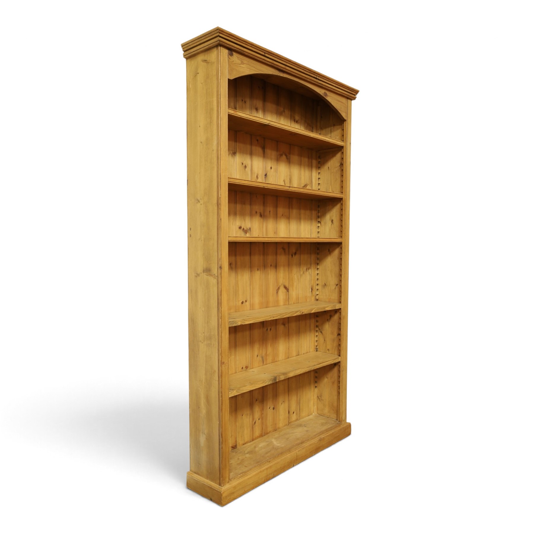 Traditional large pine bookcase, moulded cornice above five adjustable shelves