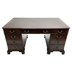 Large Georgian design mahogany twin pedestal partner's desk, moulded rectangular top with canted corners and inset leather writing surface, fitted with nine drawers and two cupboards, the pedestals with canted uprights decorated with blind fretwork, on ogee bracket feet