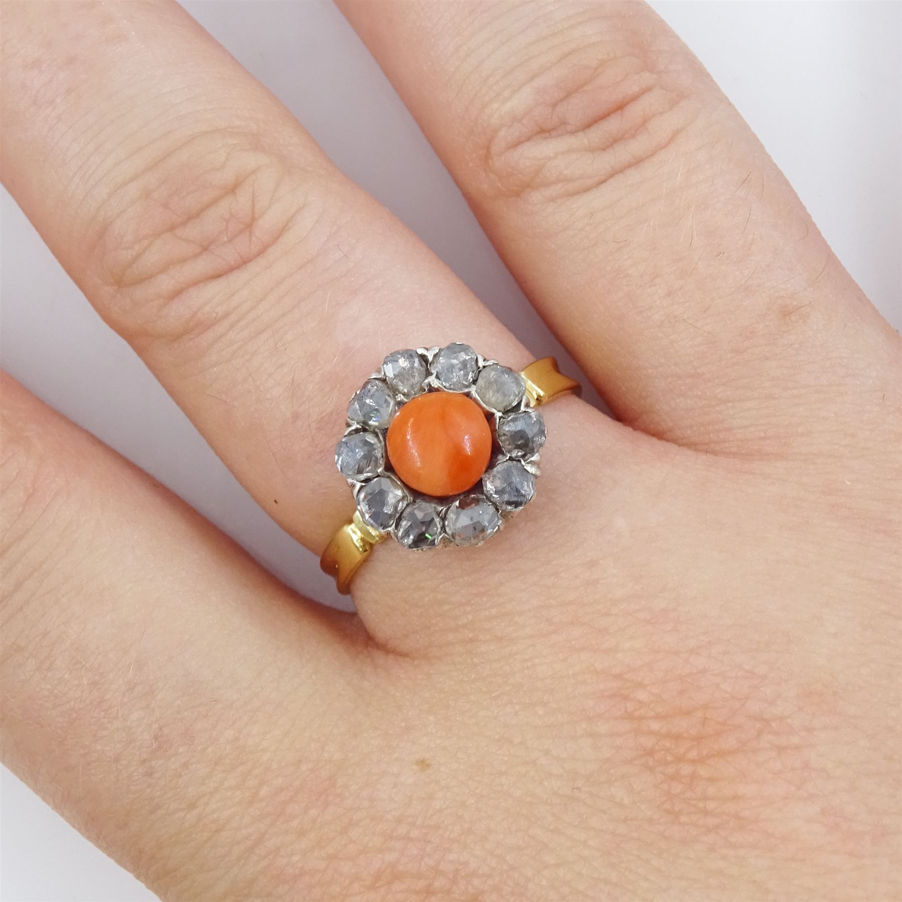 Early 20th century 18ct gold and silver coral and diamond cluster ring, single  cabochon cut coral, surrounded by ten rose cut diamond stones 