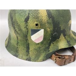 Fully restored German steel helmet, the camouflage painted exterior with two decals and replacement leather liner
