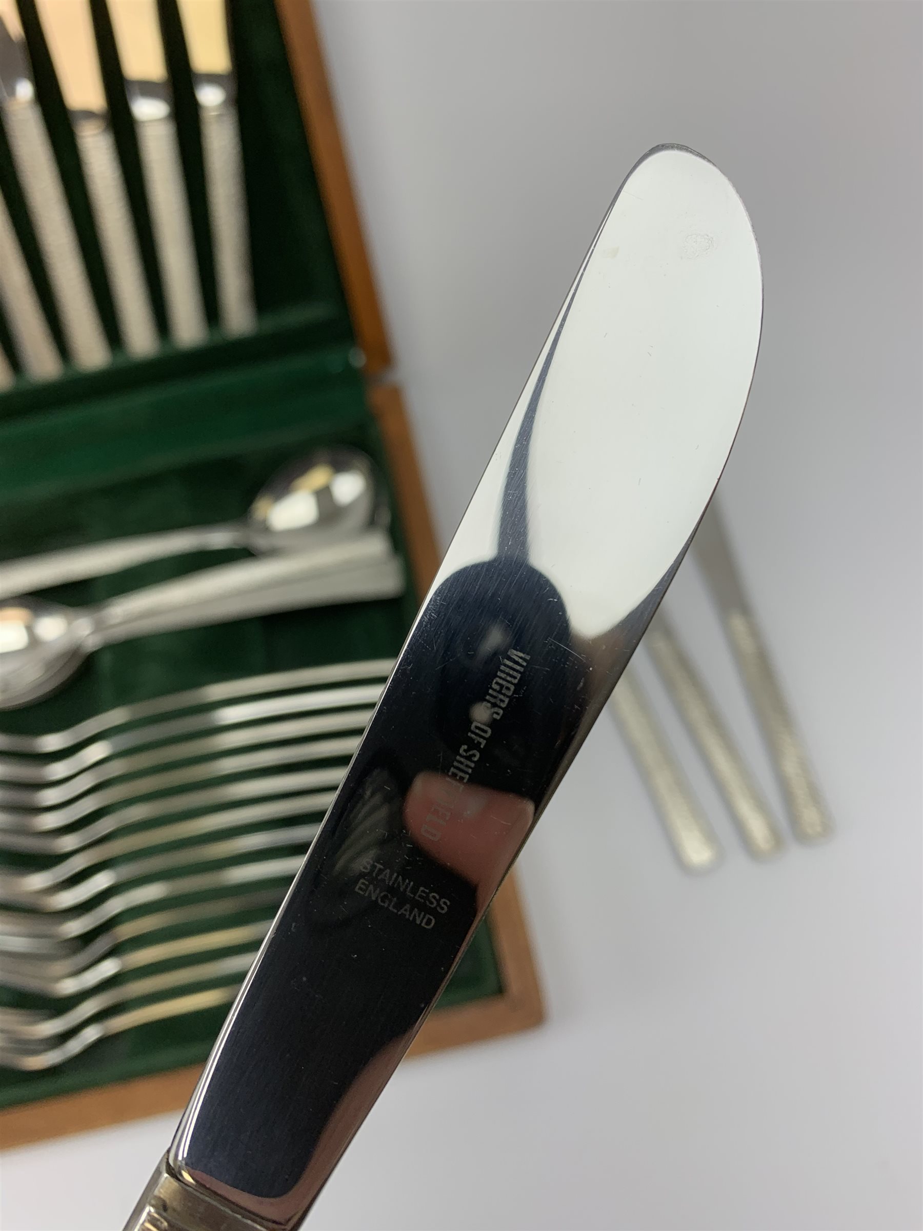A canteen of bark effect stainless steel cutlery by Gerald Benney for Viners Studio, in a teak case. 