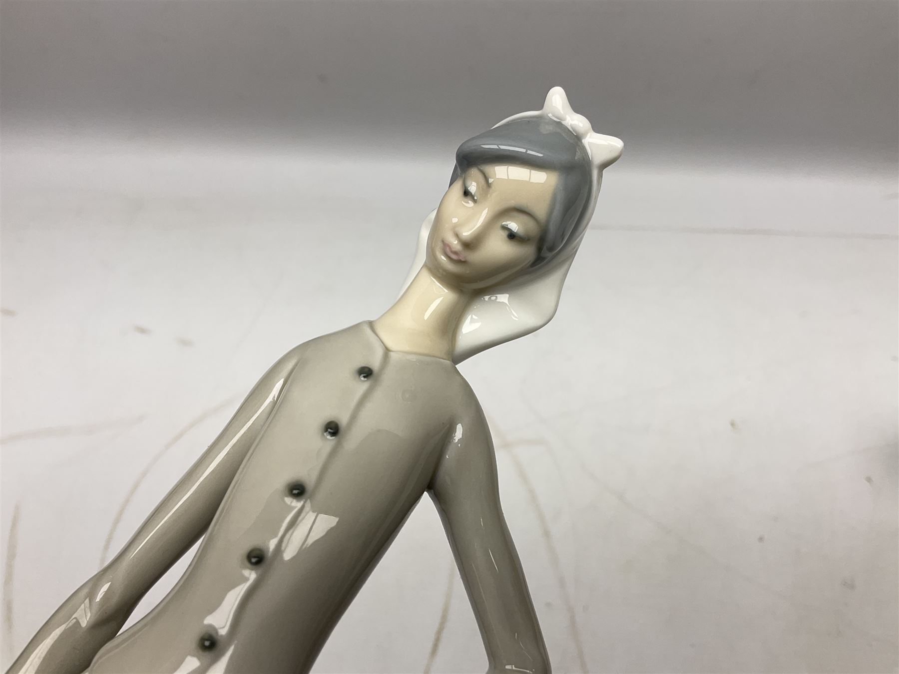 Seven Lladro figures, comprising Playful Puppy no 9135, Platero and Marcelino/Boy Hugging Donkey no 1181, Mini Seal Family no 5318, Attentive Polar Bear no 1207, Seated Polar Bear no1209, Eskimo Boy with Pet no 5238 and Girl with Geese no 1035, together with Nao goose