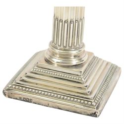 Pair of early 20th century silver Corinthian column candlesticks, upon square stepped filled bases, hallmarked Walter Latham & Son, Sheffield 1913, H16cm