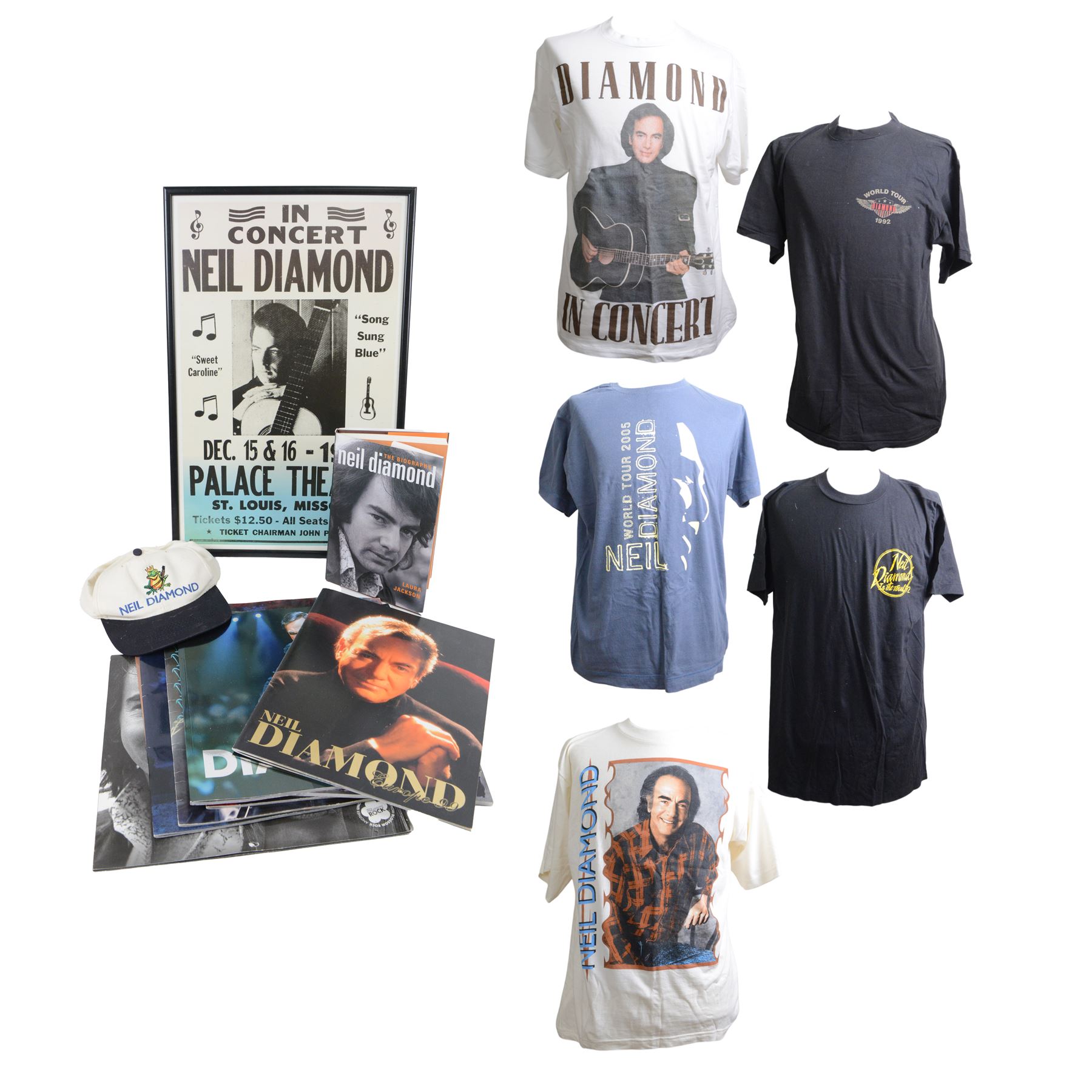 Neil Diamond tour memorabilia, including five t-shirts, cap, programmes, calendar and biography, together with a Neil Diamond In Concert poster, framed