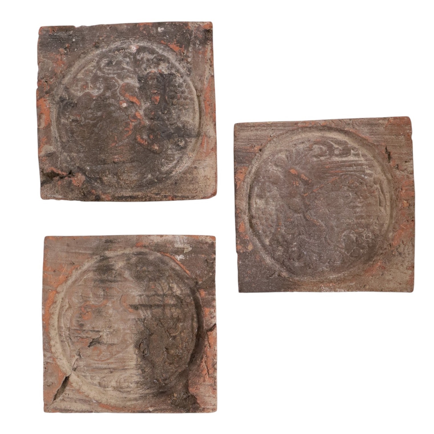 Three medieval tiles, decorated in relief, H10cm
