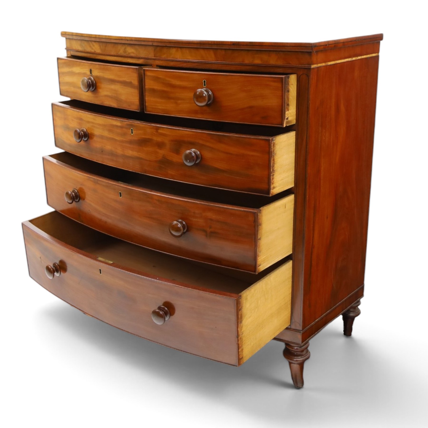19th century mahogany bow-front chest, shaped top with ebony strung edge over banded frieze, fitted with two short over three long cock-beaded drawers, on turned feet