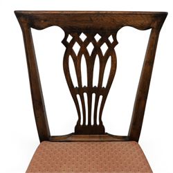 Set of eight George III dining chairs with padded seats, pierced vasiform splat, upholstered seat with brass trim, on square supports with H-stretcher