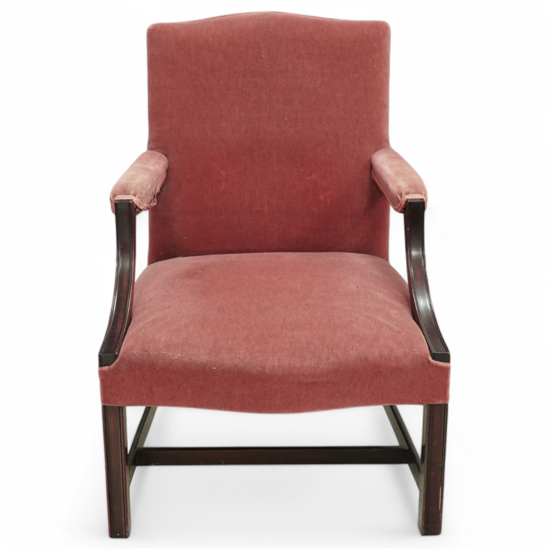 Georgian design mahogany Gainsborough chair, upholstered in pink fabric, curved and moulded arm supports, on moulded square front supports united by H-stretchers 