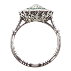 Platinum round diamond and calibre cut emerald target design ring, with diamond set shoulders
