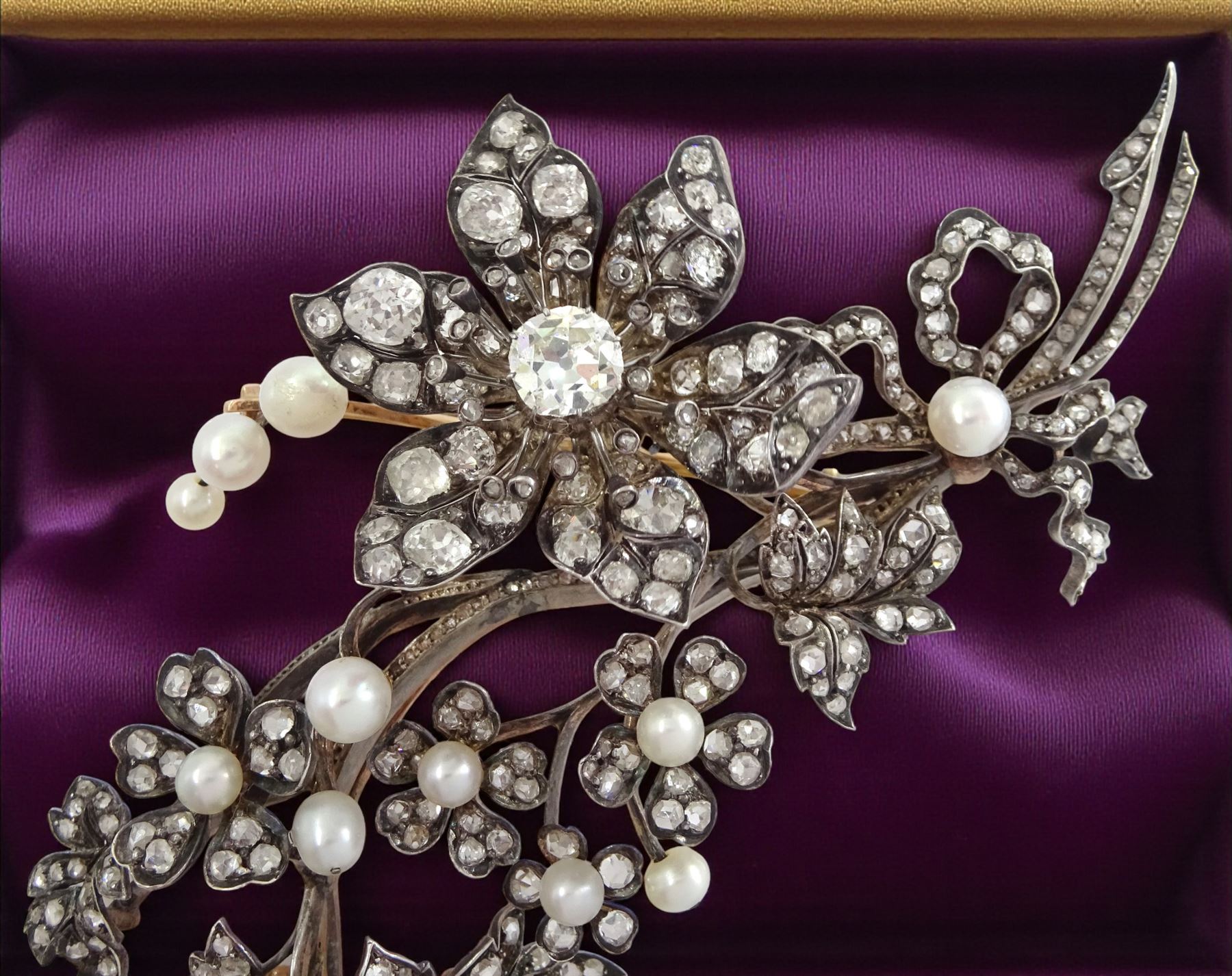 19th century gold and silver diamond and pearl en tremblant detachable brooch, the flower tremblant with a principal old cut diamond of approx 1.90 carat, the petals and stamen set with old cut and rose cut diamonds, total diamond weight approx 9.10 carat, to a foliate spray set set with further rose cut diamond and white / pink / cream pearls and ribbon tie