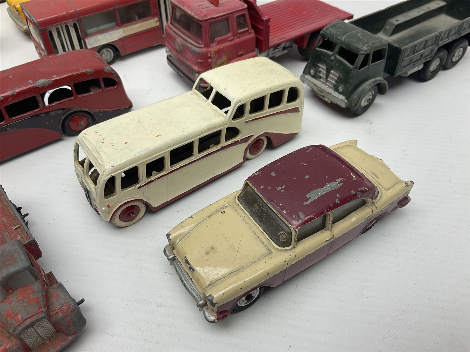 Dinky - sixteen unboxed and playworn die-cast models to include Single Deck Bus, two Atlantean Buses, Ford Transit Van, 10 Ton Army Truck, MGB Sports Car, Telephone Service Van etc 
