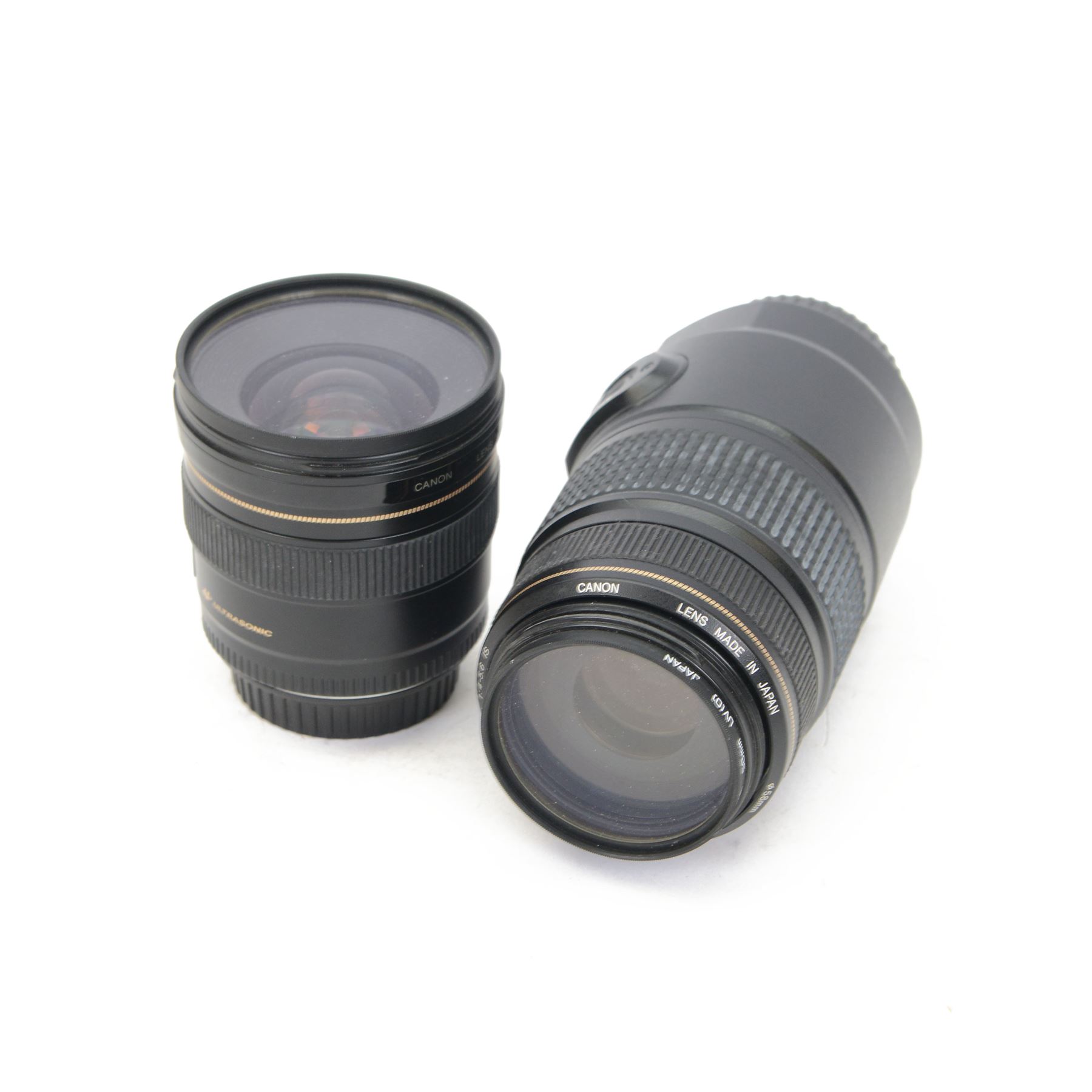 Two Canon Ultrasonic lenses, comprising EF 75-300mm 1:4-5.6 IS zoom lens serial no. 03201196 and EF 20mm 1:2.8 lens serial no. 5100131C, with a Canon EW-75II lens hood