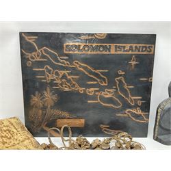 Collection of traditional necklaces from the Solomon Islands, including shell and boar tusk examples, together with a carved canoe prow, with mother of pearl eyes, painted cow hide and a copper plaque, depicting the Solomon Islands, with presentation engraving
