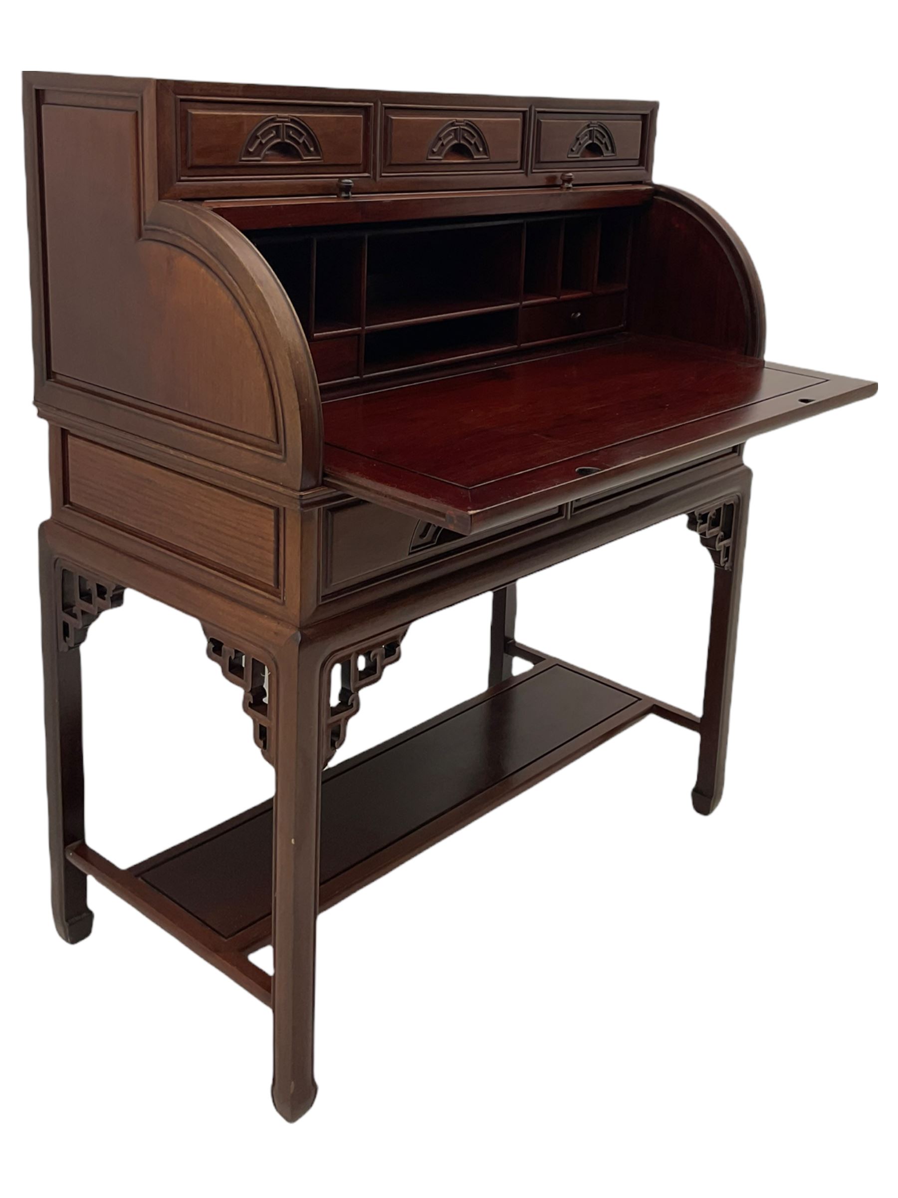 Hardwood cylinder desk, three drawers raised over curved lid, fitted interior with slide, the supports joined by undertier with fret work brackets 