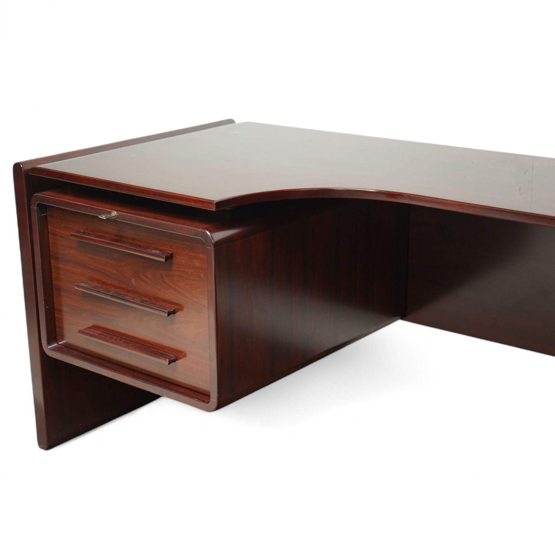 Dyrlund - contemporary Santos rosewood executive desk set, main desk with a rectangular top and leather writing pad above, floating drawer unit with right-angled desk unit top with document tray above a filing drawer 

Note: Dyrlund is a Danish furniture manufacturer known for its high-quality, handcrafted pieces, particularly in the mid-century modern style. Founded in 1960 by Frits Hjerte Dyrlund in Rude, Denmark, the company has remained a family business, now run by the second and third generations. Dyrlund specializes in both home and executive office furniture, focusing on practicality, solid construction, and classic design