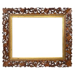 20th century rectangular wall mirror in walnut frame carved and pierced with foliage and berry decoration, carved and gilt slip