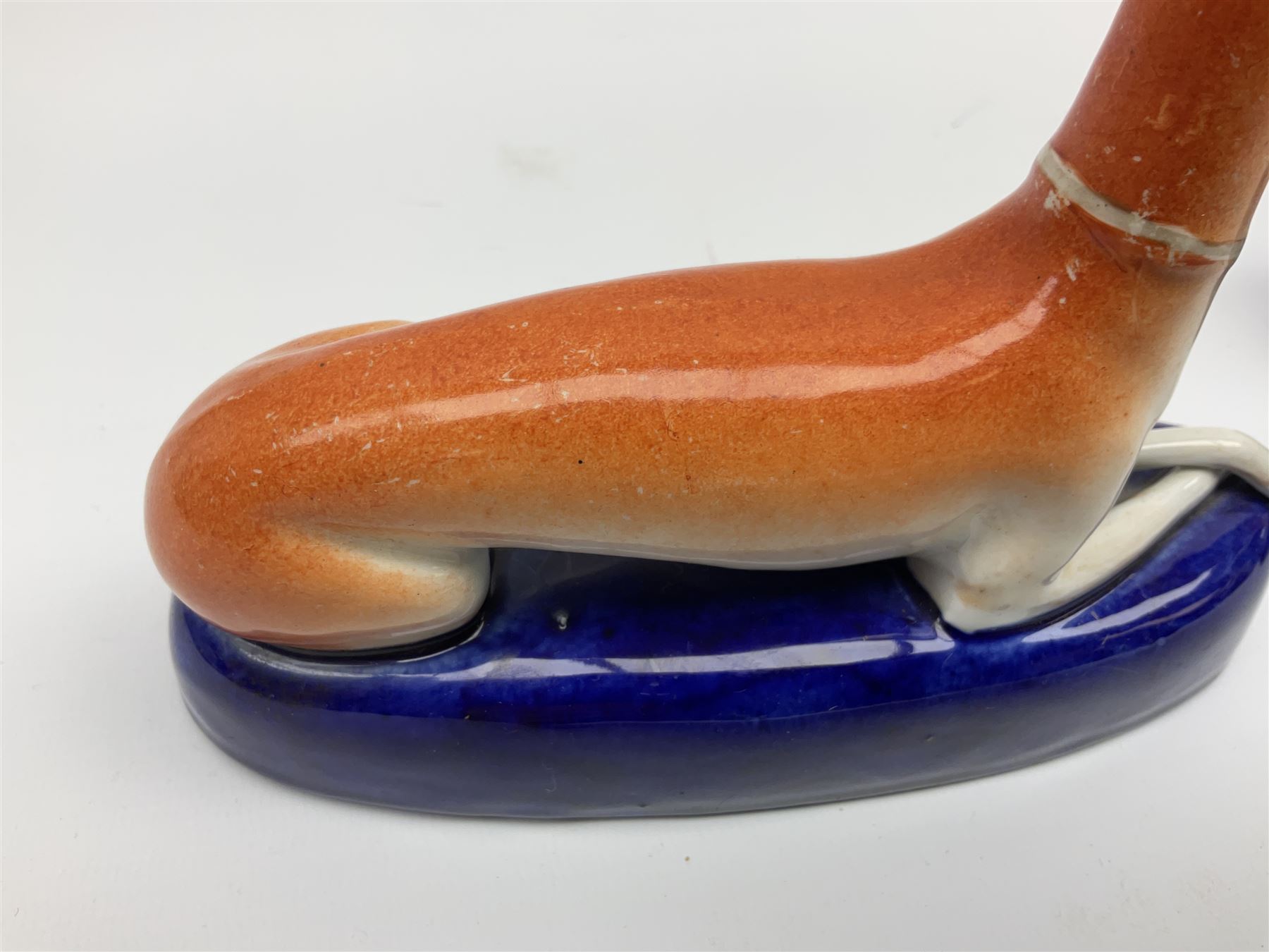 Pair of Staffordshire recumbent greyhound pen holders 