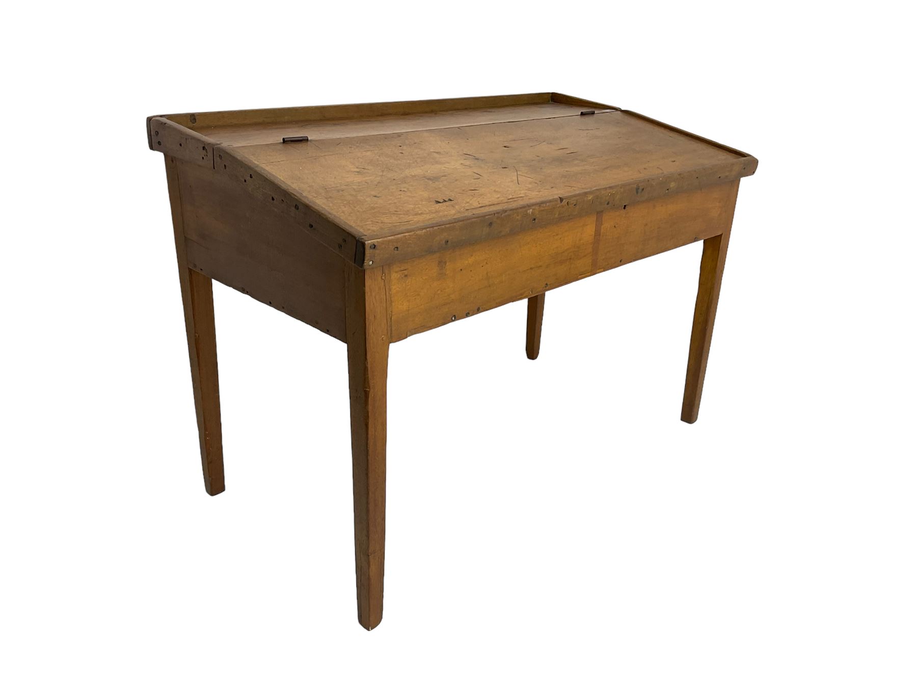 Late 19th century walnut school desk, sloped hinged lid, on square tapering supports 