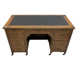 Late 19th century burr oak writing desk, fitted with nine drawers, inset writing surface, enamel castors