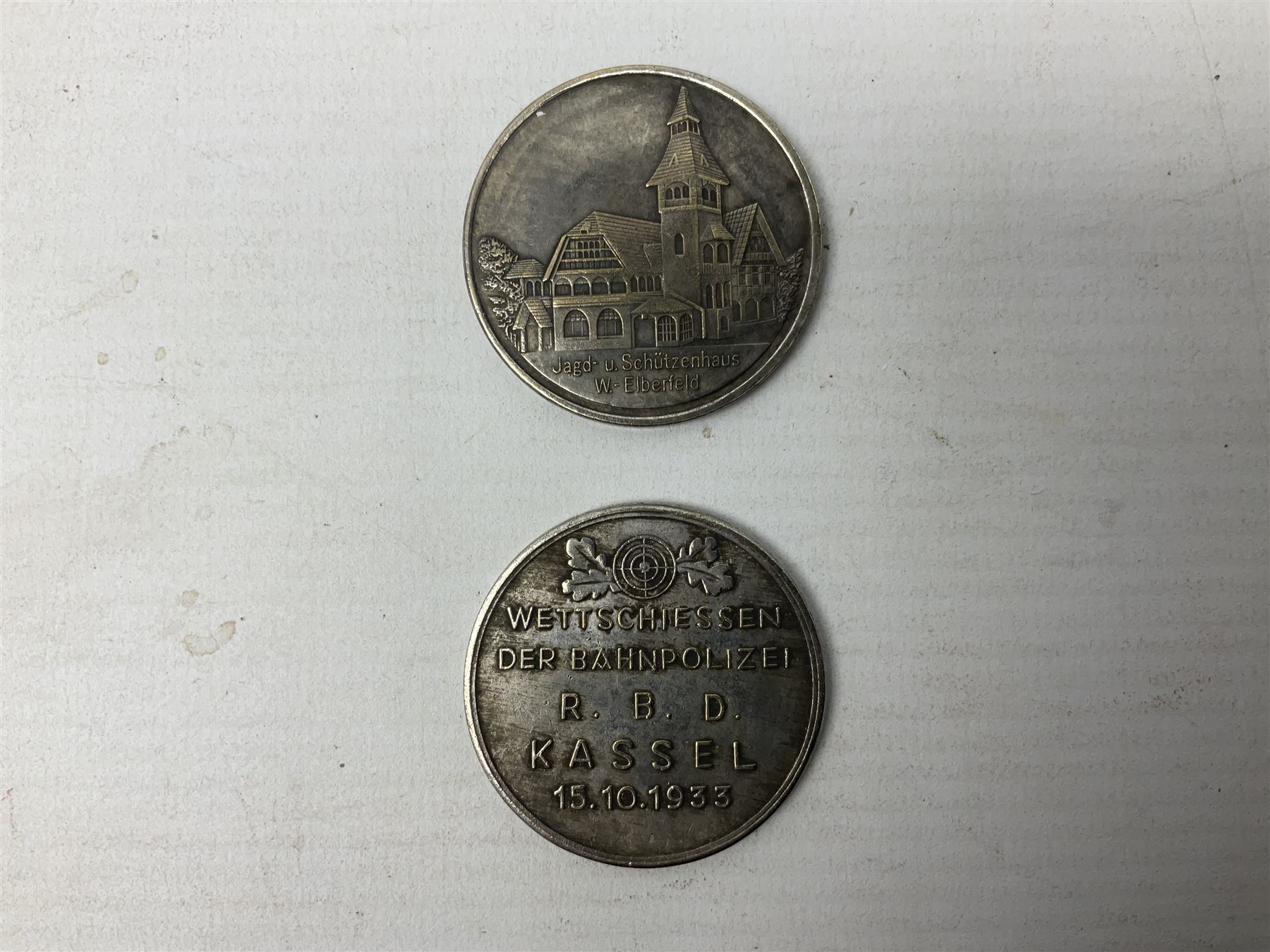 Four post-WW2 'silver' medallions of Adolf Hitler/German interest, two depicting Von Hindenburg also; and pair of 1960s trench art shell case bases as ashtrays mounted with Libyan Five Milliemes coins as cigarette rests (6)