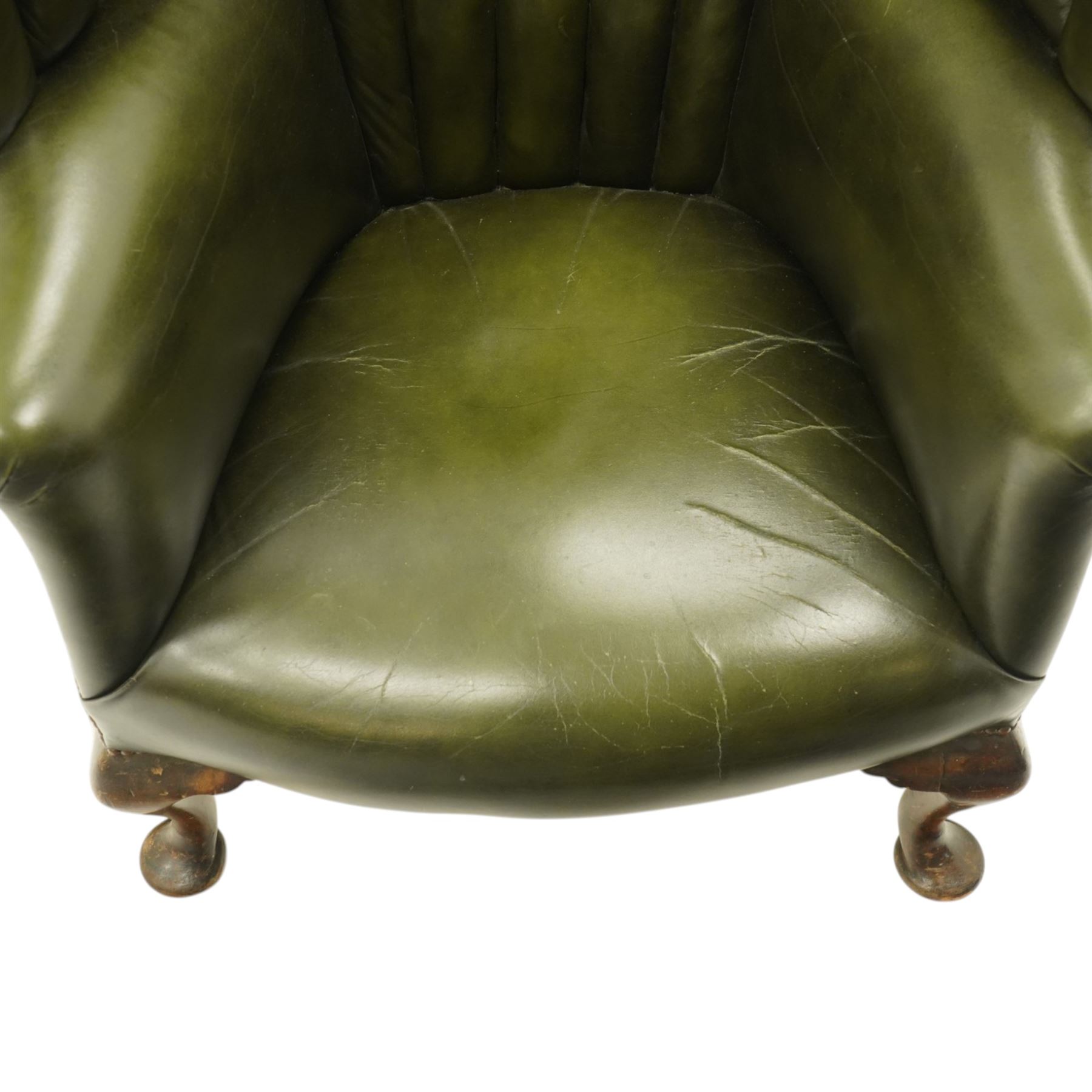 Georgian design green leather barrel-back wingback armchair, pleated upholstered back with shaped wings over scroll arms and sprung-seat, close nailed border, raised on cabriole supports terminating in pad feet