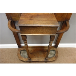  Early 20th century oak hall stand, central bevelled mirror above carved panel, hinged compartment, turned supports with stick and umbrella stands, W85cm, H215cm, D34cm  