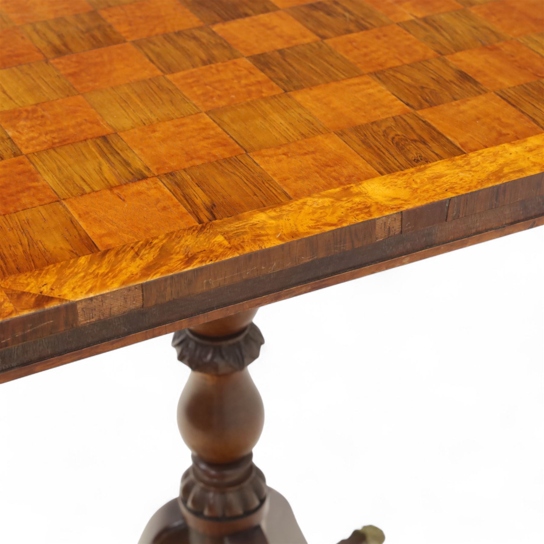 Early 20th century walnut chess table, square checkered veneered top with crossbanded edge, raise on a turned column based with acanthus craving, on three outswept legs terminating in brass paw caps above castors