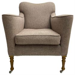 William Yeoward - traditionally shaped beech framed armchair, shaped back over shaped and rolled arms, upholstered in herringbone wool fabric in shades of light pink and grey with stud work, turned front supports on polished metal castors