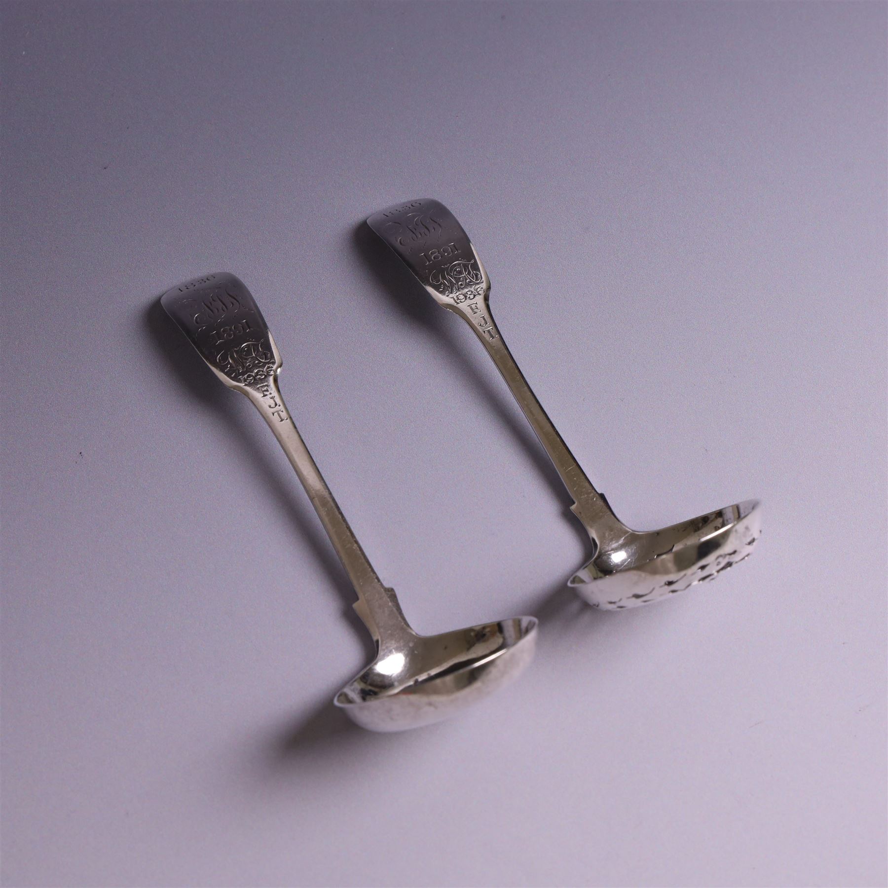 Pair of William IV silver Fiddle pattern spoons, comprising ladle and sifting spoon, each with presentation engravings to terminal, hallmarked William Rawlings Sobey, Exeter 1836