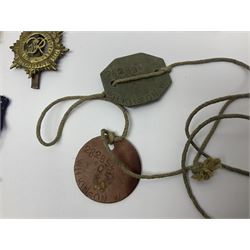 WWII group of three medals comprising 1939-45 War Medal and Italy and Africa Stars in issue box; dog tags for 282894 W. Wilkinson with framed photograph in uniform; and small quantity of cloth and metal badges including RAOC cap badge