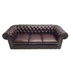 Thomas Lloyd - three seat Chesterfield sofa, upholstered in buttoned oxblood leather, on castors 