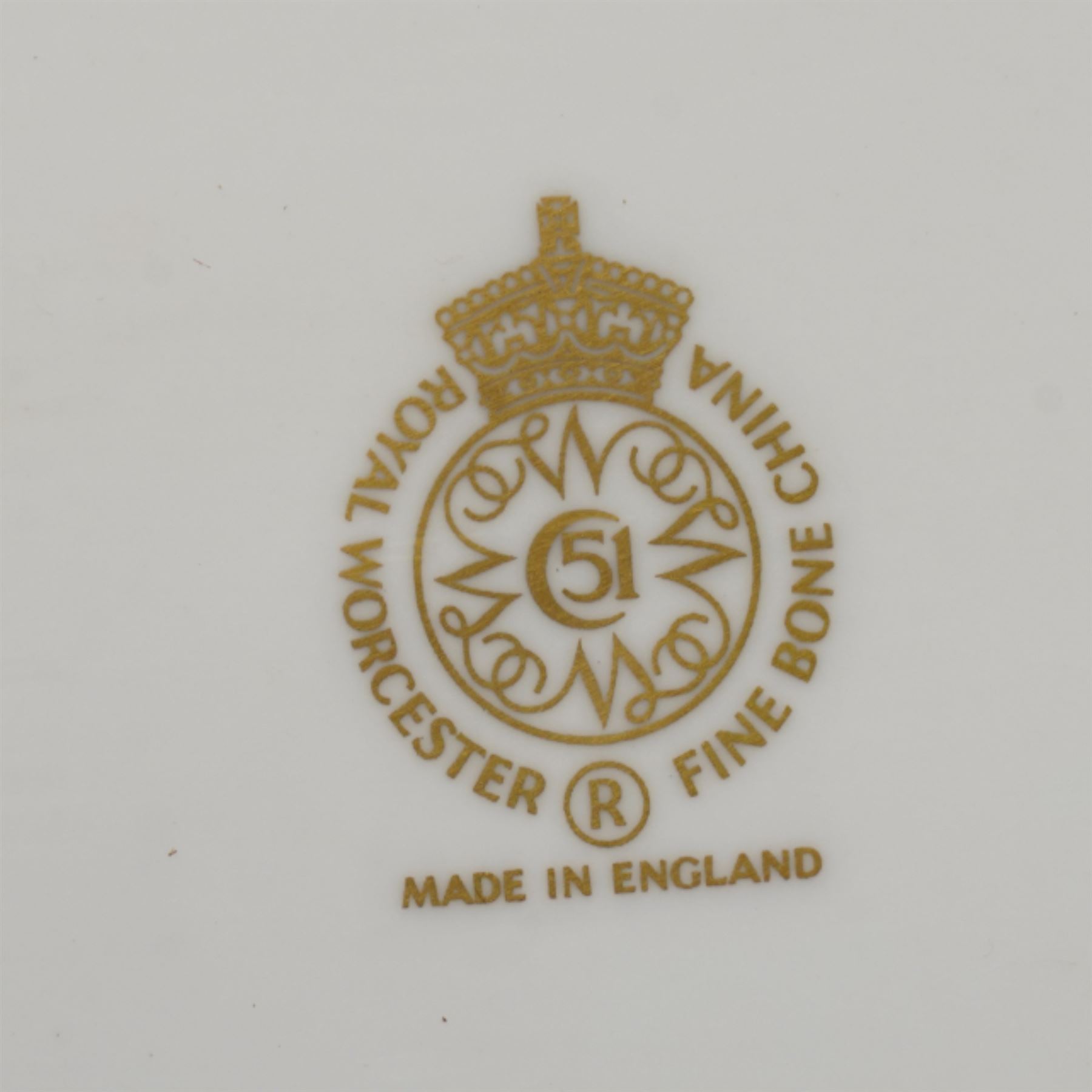 Pair of Royal Worcester cabinet plates painted with central panel of fruit by Peter Platt signed 'P Platt' within a green and gilt surround D27cm