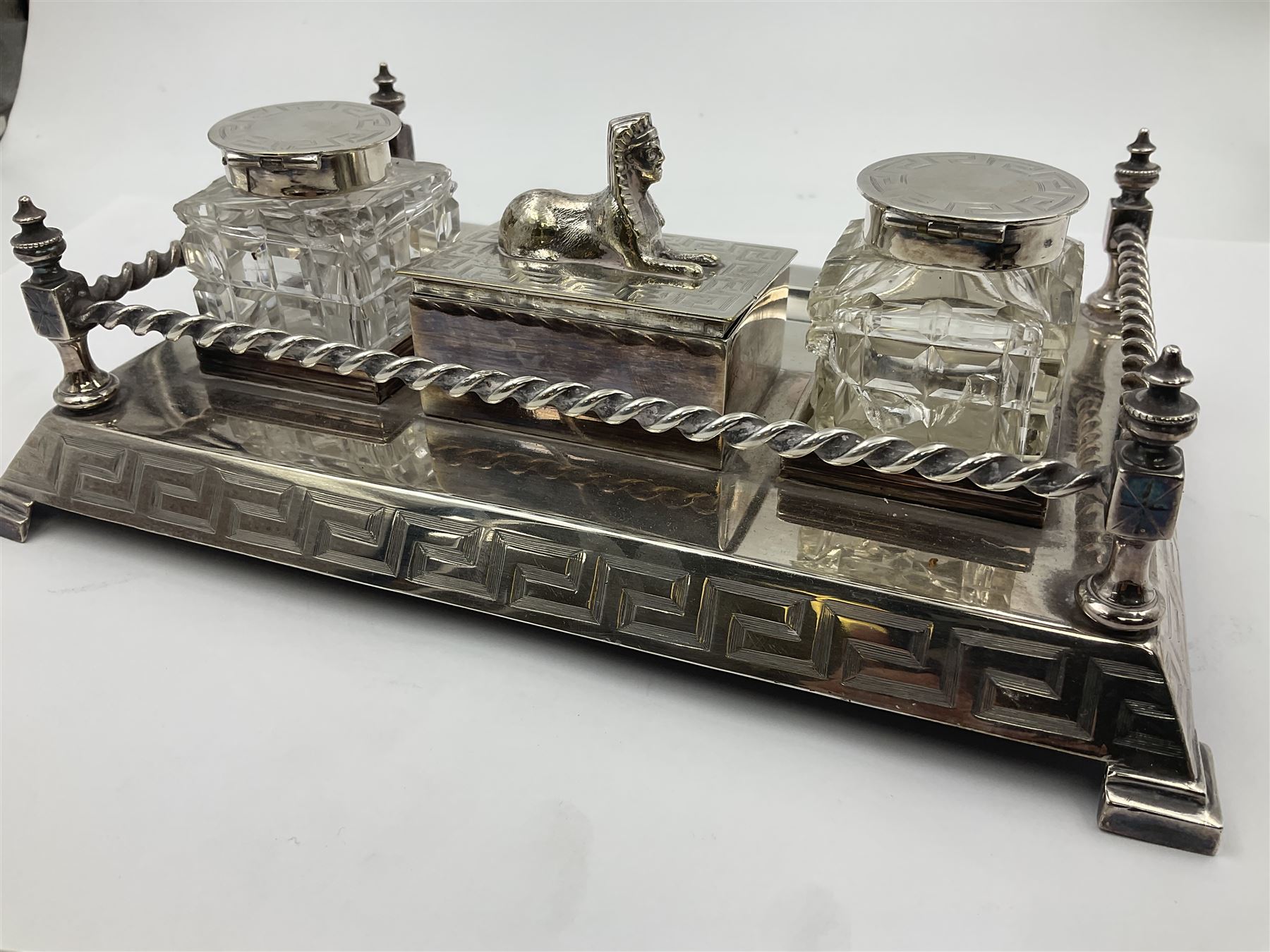 Egyptian Revival style desk stand, with pen tray and two glass inkwells, upon four bracket feet, W23cm
