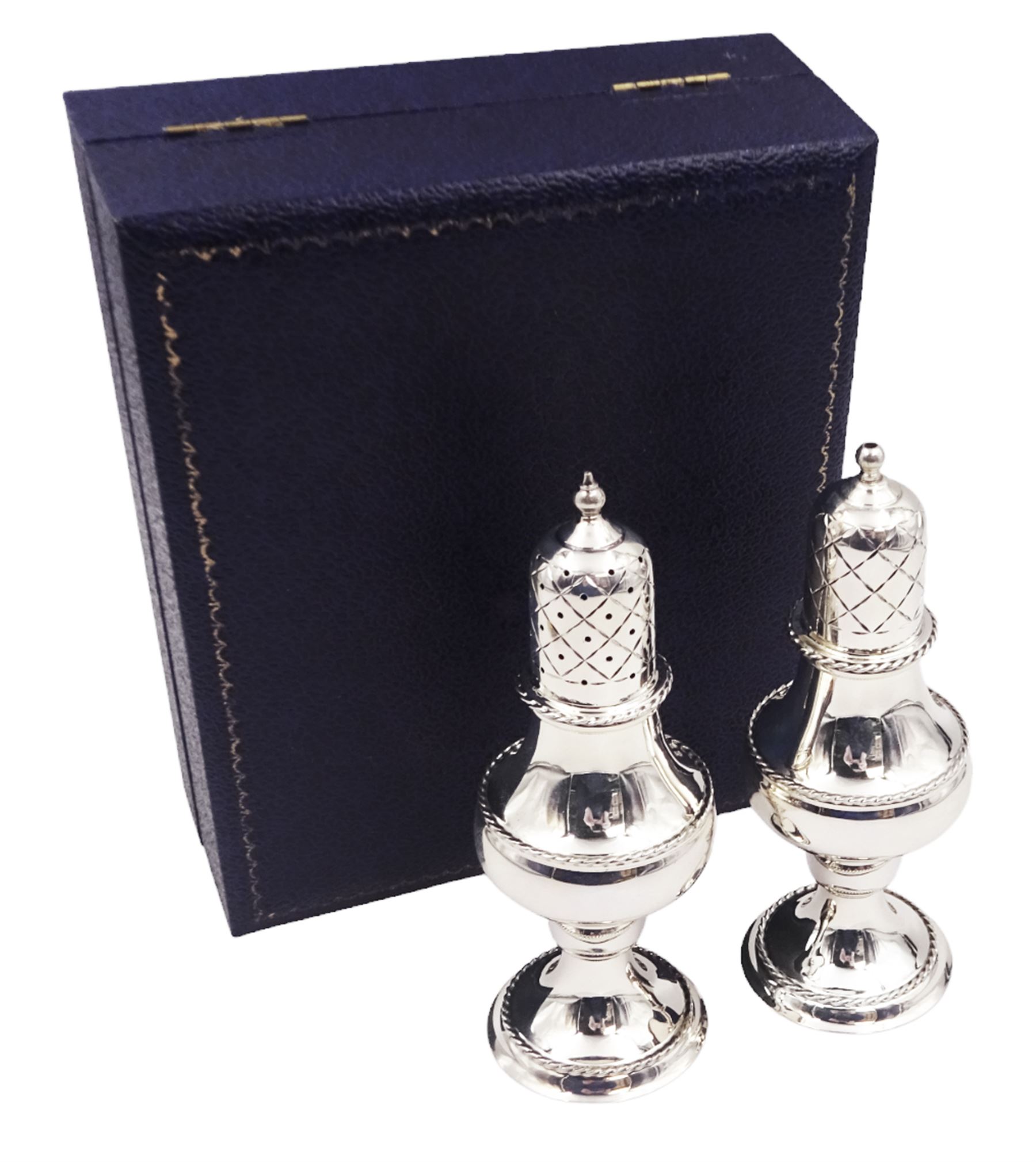 Modern silver two piece cruet set, comprising salt shaker and pepper shaker, both of waisted form with engraved rope twist borders, the removable pierced covers each with engraved lattice decoration, upon a circular spreading foot, hallmarked Laurence R Watson & Co, Birmingham 1989, H14.5cm, contained within velvet lined fitted case