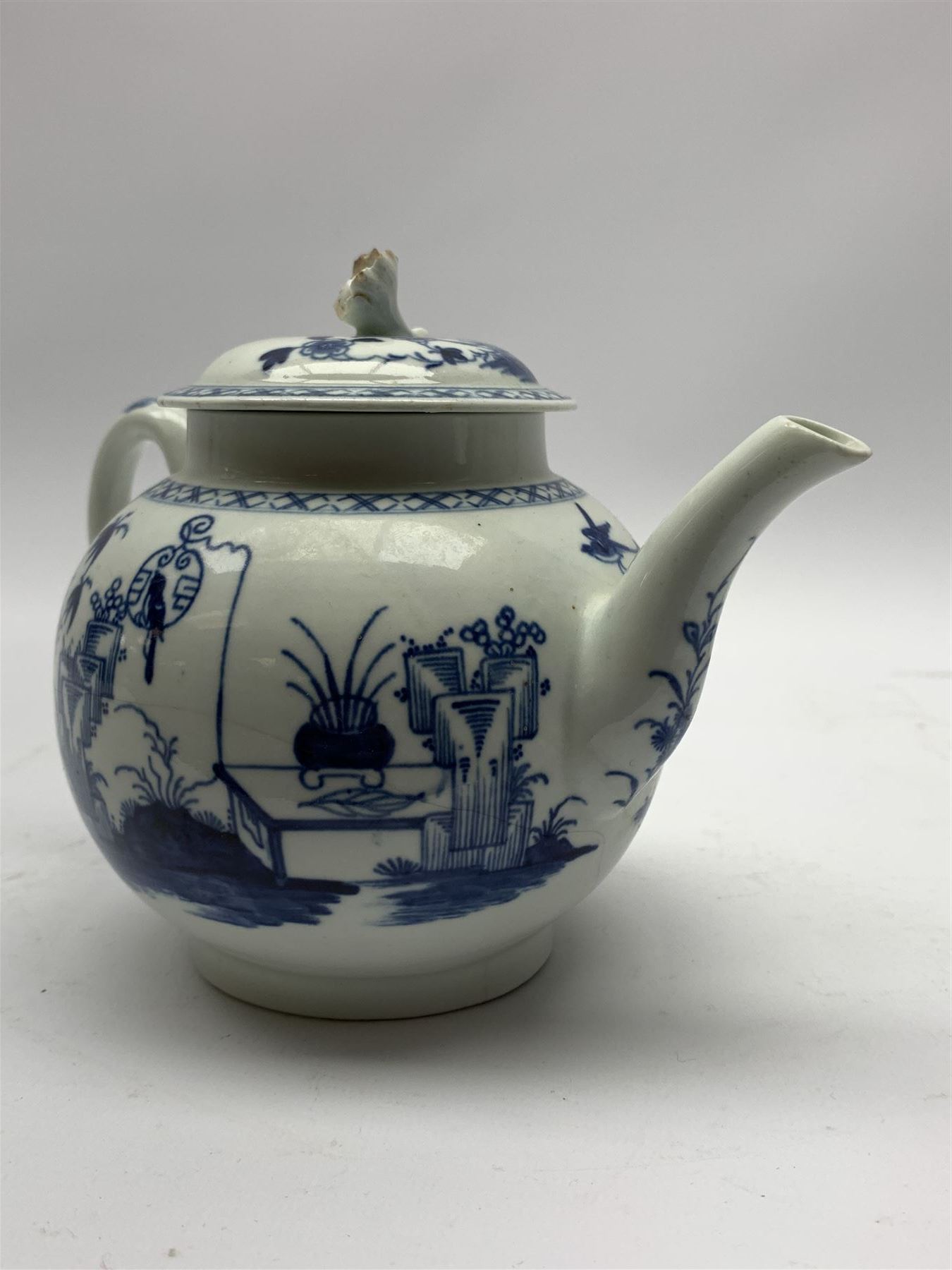18th Century Worcester teapot, circa 1765-70, decorated in the Bird in the ring pattern, the cover with bud finial, with crescent mark beneath, H13cm, together with a Worcester coffee cup decorated in the same pattern, with crescent mark beneath, H6.5cm