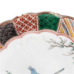 Pair of Japanese Edo period Ko Kutani dishes, decorated in green, yellow, blue iron-red, and aubergine enamels, the centres painted with a singing bird perched on a rock among foliage, within a border of alternating geometric designs and a chocolate-brown rim, the reverse with underglaze blue foliage, Fuku mark, D20.8cm (2) A matching pair of dishes is held in the collection of the Cleveland Museum of Art (see accession no. 1964.262)