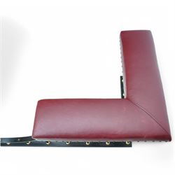 Wrought metal and brass fire fender, L-shaped corner seats upholstered in burgundy fabric with stud bands, dished centre on balustrade and plain curb  
