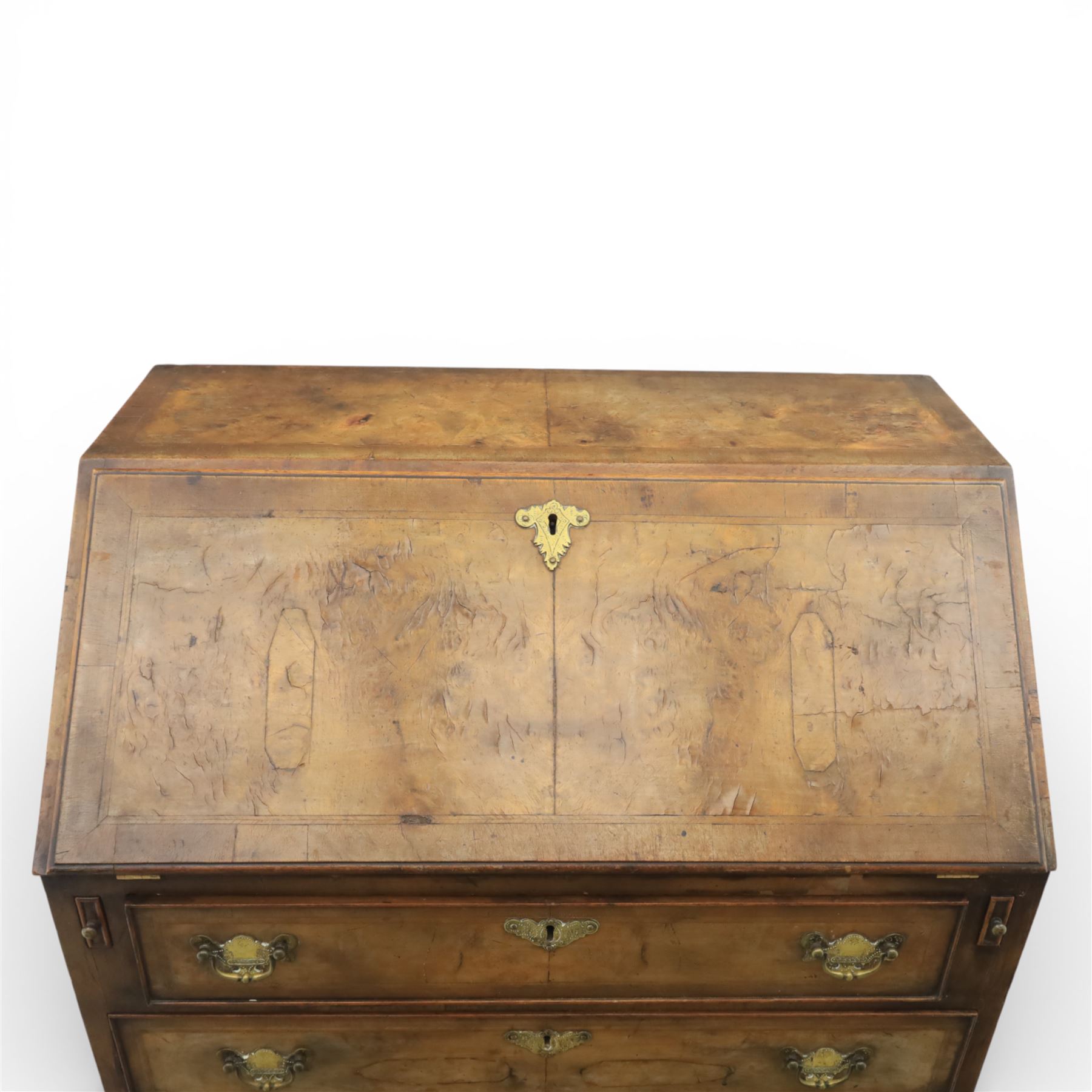 19th century walnut bureau of small proportions, the sloping fall enclosing a fitted interior with shaped pigeonholes and small drawers, above four long graduated drawers with feather banded walnut veneers, fitted with brass swan neck handles and escutcheons, raised on shaped bracket feet