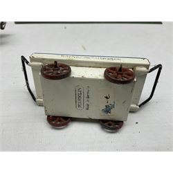 '0' gauge - Bing tin-plate two-storey double sided station with open walk-through to one end, rail side canopy, hinged doors and removable roof giving access to clock illumination L35cm; Bing hand-cranked turntable and open wagon; Marklin tin-plate level crossing barrier and Newspaper vendor's tin-plate four-wheel hand cart (5)