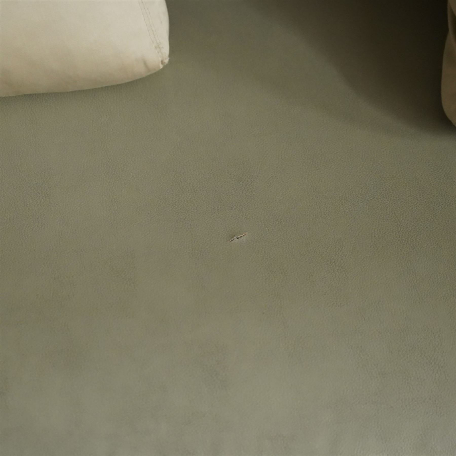 Christian Liaigre (1943-2020) - 'Arpege' handmade L-shaped sectional sofa, upholstered in neutral leather, with broad squared arms, deep seat cushions, angled chaise section, loose back cushions, raised on block feet