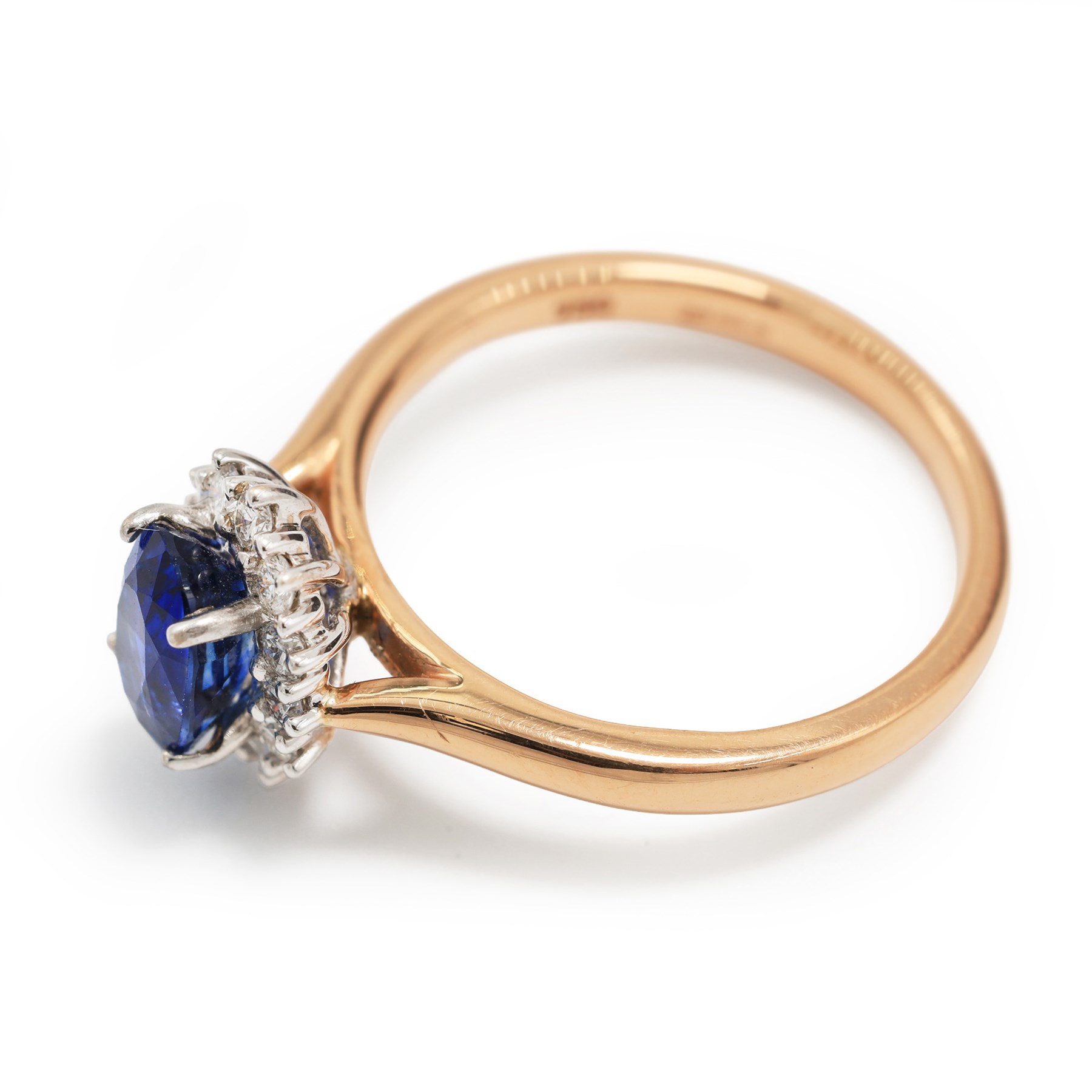 18ct rose gold sapphire and diamond cluster ring, single oval cut sapphire of approx 1.25 carat, with round brilliant cut diamond surround, hallmarked, total diamond weight approx 0.25 carat