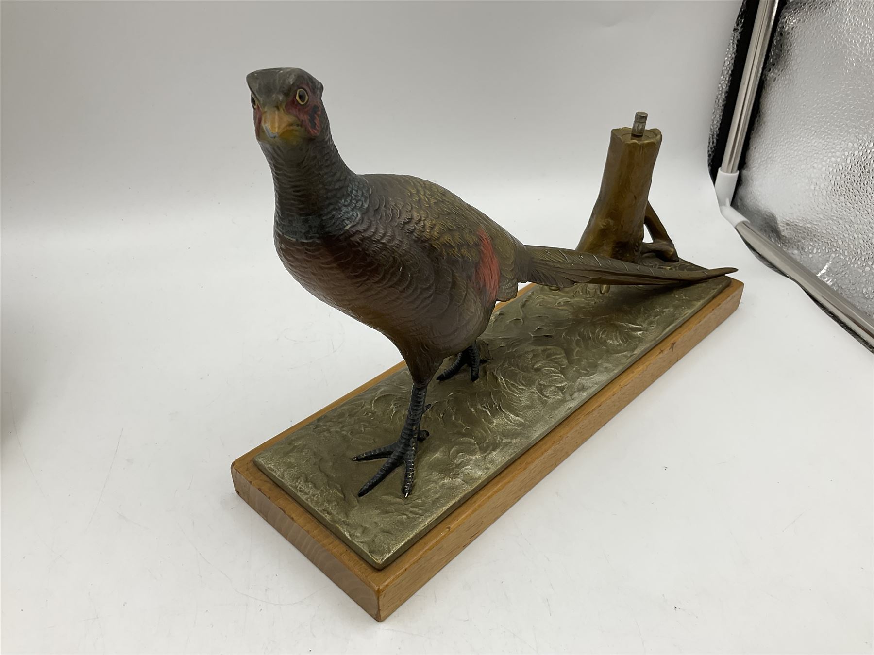 Austrian cold painted spelter table lighter modelled as a pheasant beside a tree stump, on rectangular oak plinth, L31.5cm x H21cm 